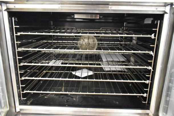 Brand new 2022 Blodgett Zephaire-200-E stainless steel convection oven with view-through doors, metal racks, and casters.