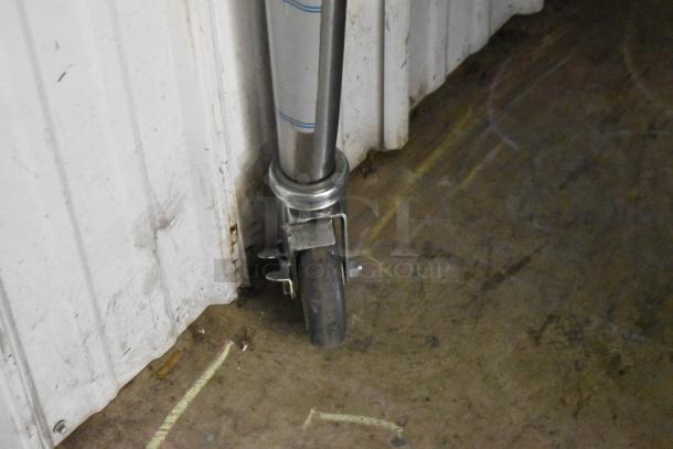 Wheel and stainless steel leg of a Blodgett Zephaire-200-E convection oven on a commercial caster, shown against a wall.