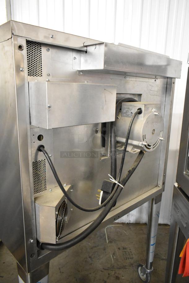 Blodgett Zephaire-200-E convection oven, stainless steel, view-through doors, metal racks, thermostatic controls, on casters.