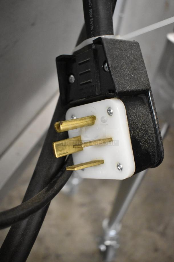 2022 Blodgett Zephaire-200-E plug detail, showcasing metal prongs and black casing for commercial convection oven, 208V, 3-phase.
