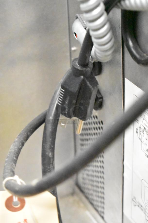 Power cord and label on a 2016 Blodgett DFG100 Stainless Steel full-size convection oven, new with minor scratches.