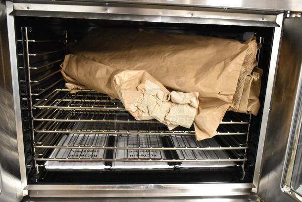 Brand new 2019 Blodgett Zephaire-100-G convection oven with view-through doors, metal racks, and caster legs. 50,000 BTU.