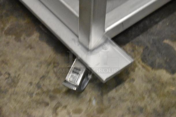 Brand new Blodgett metal portable rack for combi convection ovens, scratch and dent condition, visible caster wheel.