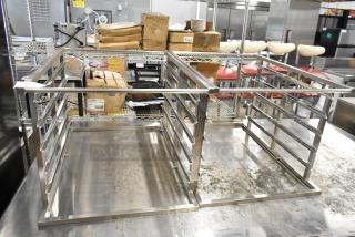 2 Blodgett metal racks, scratch and dent condition, stainless steel, open frame design, on a steel countertop.