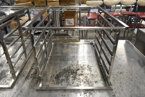 Two new Blodgett metal racks, slightly scratched, on display. Robust design, perfect for commercial kitchens.