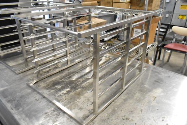New Blodgett metal rack, scratch and dent condition, stainless steel, multiple shelves, durable construction.
