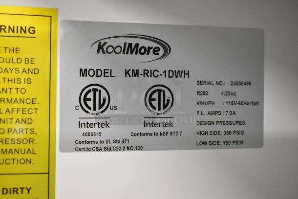 alt_text: KoolMore KM-RIC-1DWH label showing model, serial number, 115V, ETL certification, NSF compliance, and design pressures.