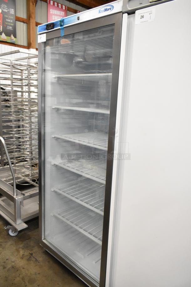 Brand new KoolMore KM-FMD20WGD 21 Cu. Ft. commercial freezer with glass door, 115 volts, 1 phase, visible shelving.