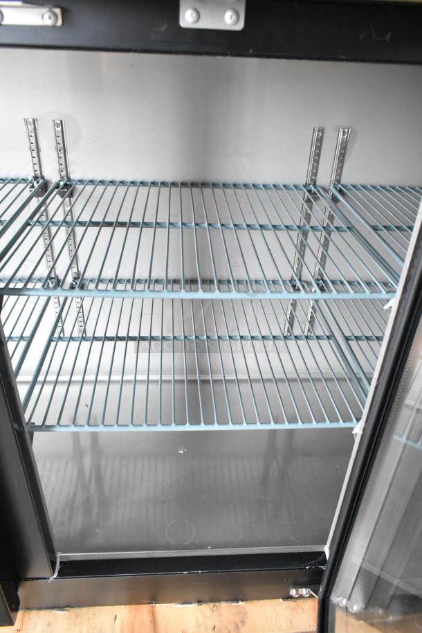 BRAND NEW Avantco 2024 model 178UBB72GHC 73" black bar fridge with LED lighting, glass door, and adjustable shelves.