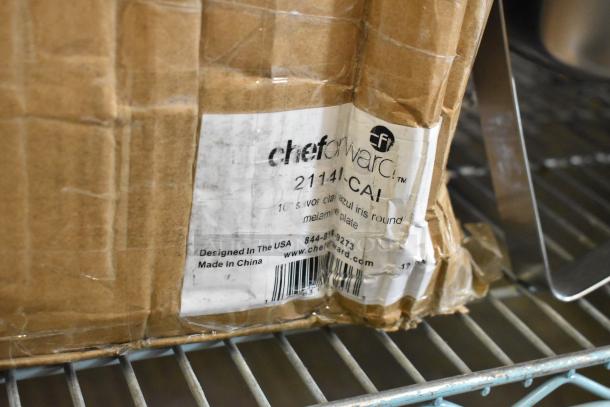 Box of cheforward™ 10" Savor clay azul iris melamine plates, 12 per case. Label indicates "scratch and dent" condition.
