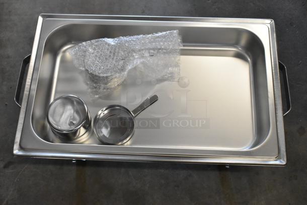 Brand new stainless steel chafing dish with visible bubble wrap, slight scratches, includes two food pans.