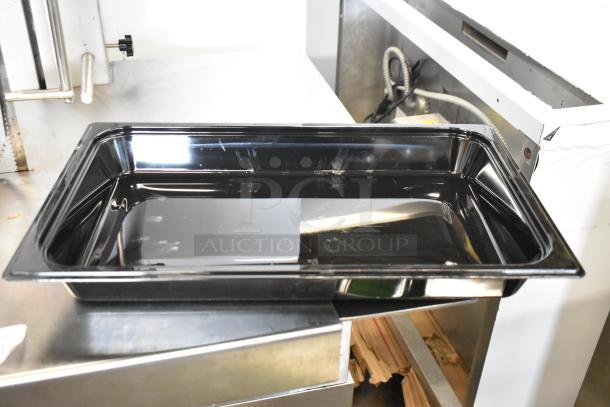 Brand new Vigor black poly full-size drop-in bin, visible scratch and dent, ideal for kitchen use.