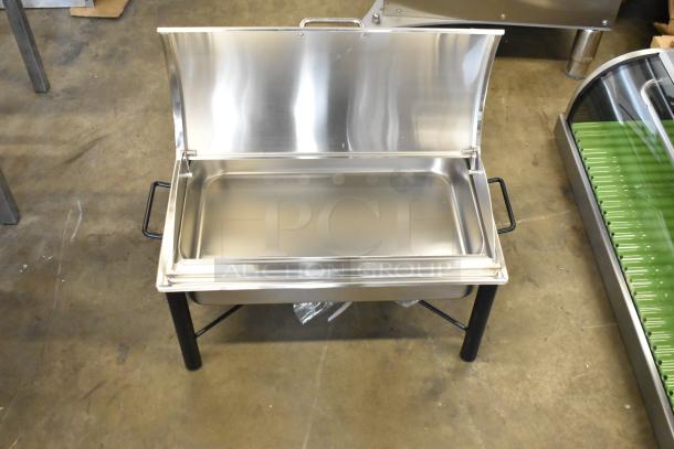 Stainless steel countertop chafer, brand new with minor scratches. Features black handles and a hinged lid for easy use.