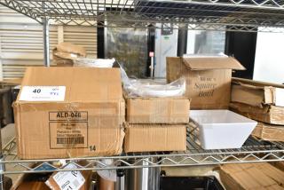 New scratch and dent boxes of Acopa 50 oz. square white melamine bowls, American Metalcraft 6 1/4" white round plates, Tuxton ALD-046 fruit bowls.