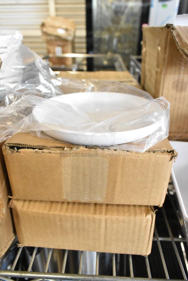 Brand new white melamine bowls in packaging, displayed on boxes. Includes Acopa and American Metalcraft sets.