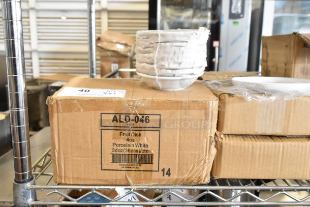 6 new boxed items including ALD-046 Tuxton Alaska 4 oz. white china bowls, 36 per case, displayed on a metal shelf.