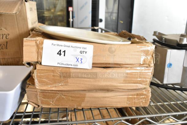 Three boxes of new white ceramic plates with slight scratches and dents. Includes 2 plates per box. Auction label reads "41 QTY X3".