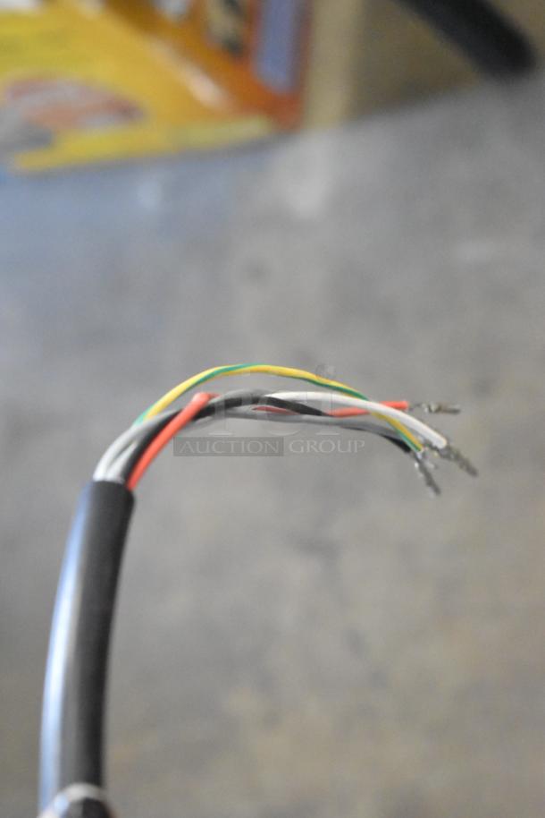 Close-up of wiring for a new motor. Multicolored wires exposed, highlighting electrical connectivity. Motor has minor cosmetic scratches.