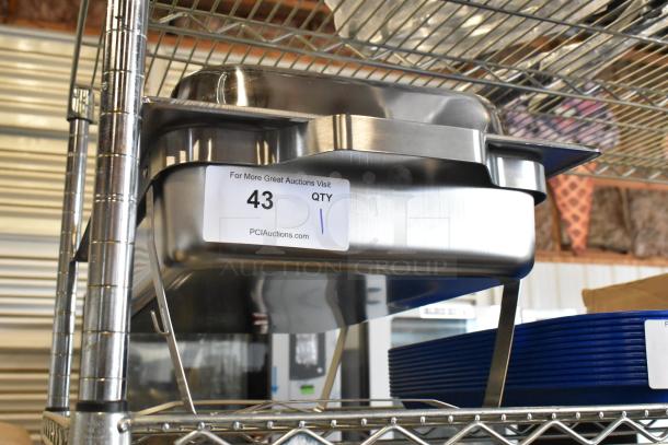 Brand new stainless steel chafer with minor scratches and dents, on a metal shelf. Tag shows auction info "43 QTY 1".