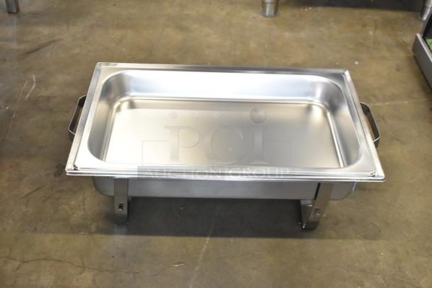 Brand new stainless steel chafer with minor scratches and dents. Sturdy, with handles and legs, ideal for buffet use.