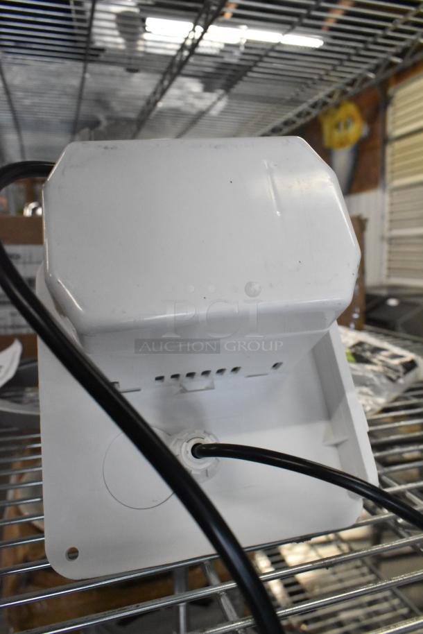 Brand new pump with minor scratches and dents, white casing, visible wiring, and ventilation slits, on metal shelving.