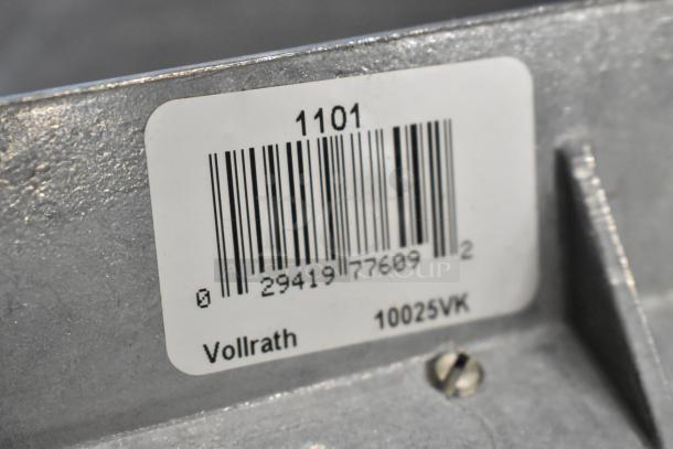 "Vollrath 10025VK metal scraper label, showing SKU, barcode, and part number on metallic surface.”