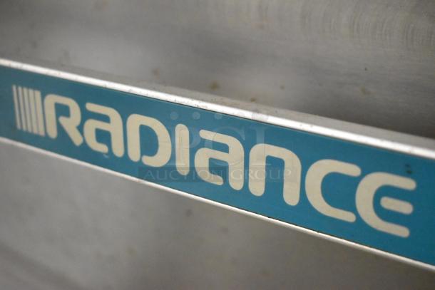 Radiance logo on stainless steel commercial gas range; features six burners, oven, over shelf, and backsplash with casters.