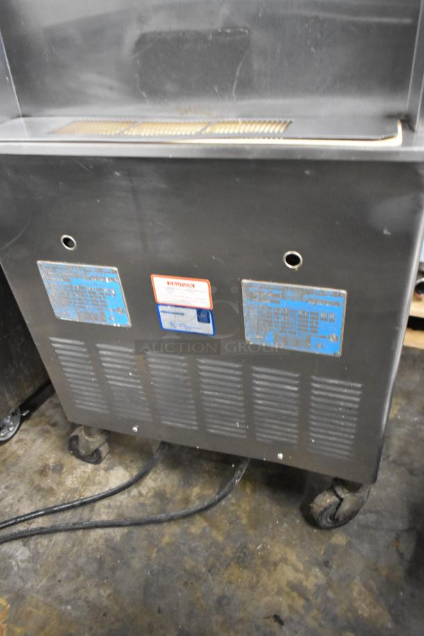 Taylor 339-27 stainless steel ice cream machine, dual flavor with twist, on casters. Visible labels show voltage details.