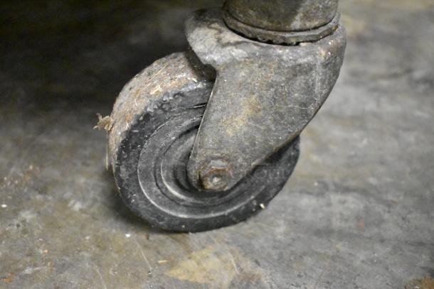Close-up of a single caster wheel on a Taylor 339-27 soft serve ice cream machine. Wheel shows signs of wear.