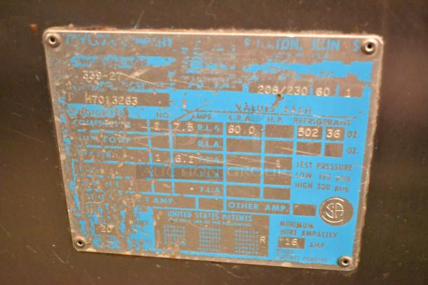 Worn label on Taylor 339-27 soft serve machine. Specs include 208-230V, 1 phase. Indicative of usage and specs.