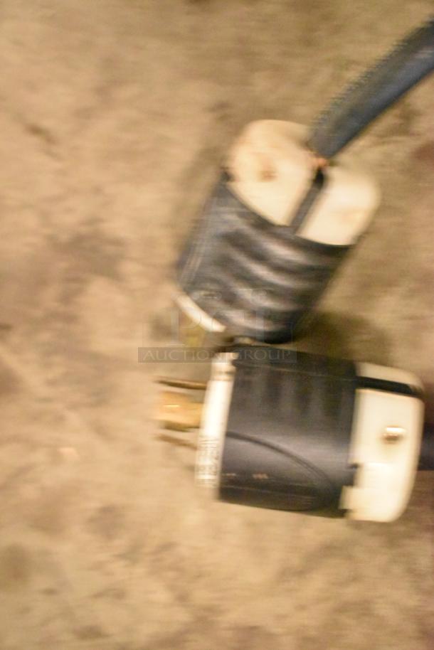 Blurry image showing a power cord and connector for a Taylor soft serve ice cream machine, model 339-27.