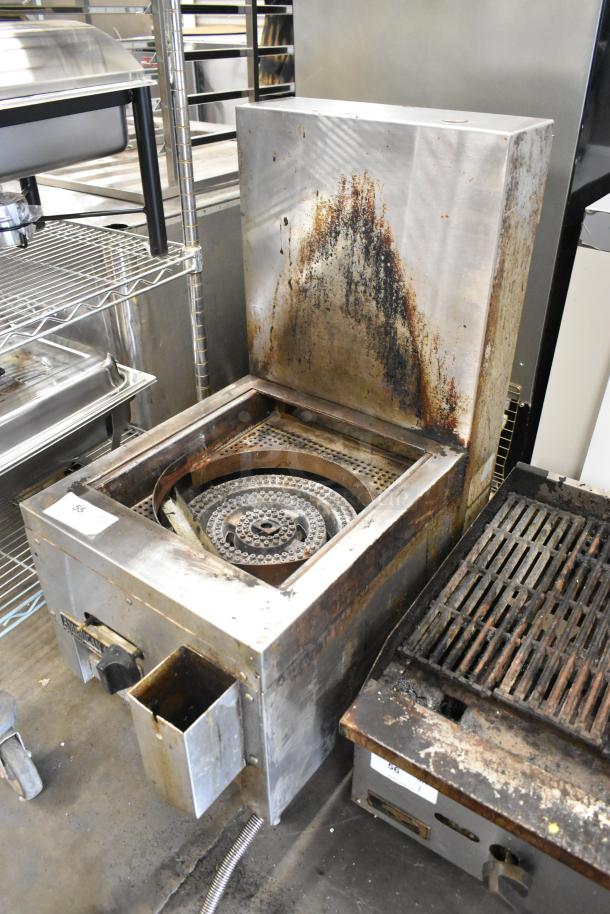 American Range stainless steel commercial single burner gas range, showing visible wear and discoloration, with control knobs.