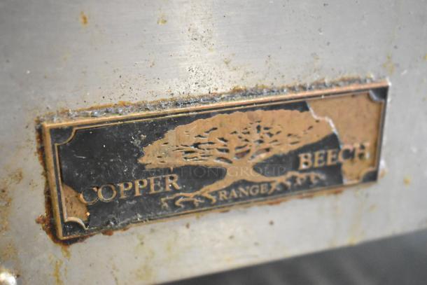 Copper Beech stainless steel commercial gas charbroiler grill with brand label, showing signs of use.