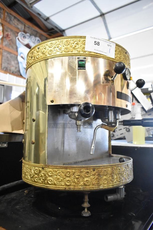 Grindmaster 2100Q Espressimo commercial espresso machine with ornate metal design, 2 group heads, 2 portafilters, and steam wand.