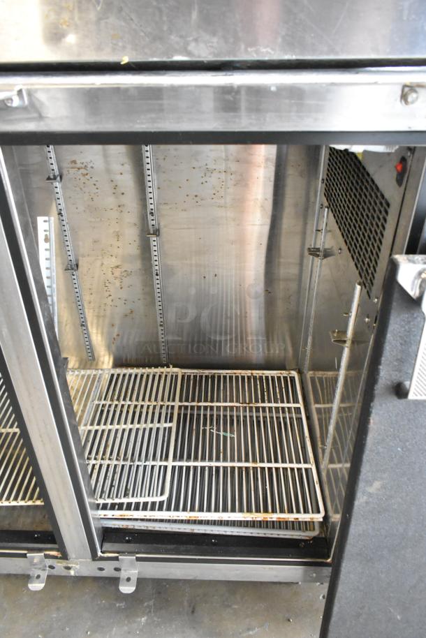 Glastender ND72-R1-BN(LLR) metal commercial 3-door back bar cooler, 115V, shows interior shelving and moderate wear.