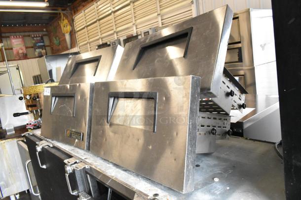 4 True stainless steel commercial freezer drawers, durable, excellent condition, undercounter design, label visible.