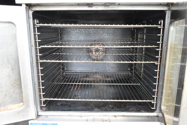 Duke stainless steel commercial convection oven, gas-powered, view-through doors, metal racks, thermostatic controls.