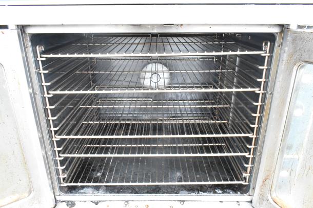 Duke stainless steel commercial gas convection oven with view-through doors, metal racks, thermostatic controls.