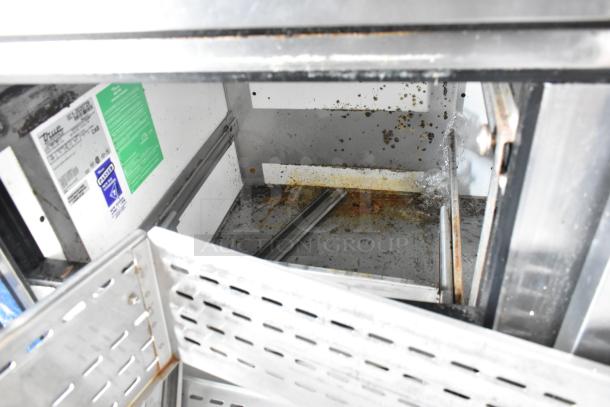 True TWT-93D-6 commercial undercounter cooler interior with visible rust and wear. Labels indicate 115 volts, 1 phase.