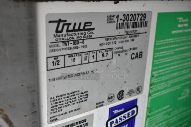 True TWT-93D-6 undercounter cooler label with model info, 115V, 1 phase, 1/2 HP, NSF listed. Serial number visible.