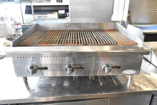 Atosa stainless steel commercial countertop gas charbroiler grill with three control knobs, in used condition.