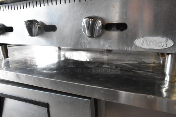 Atosa stainless steel commercial charbroiler grill, gas-powered, with visible control knobs and Atosa logo, in used condition.
