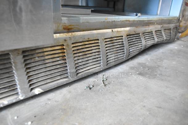 Delfield UCD4464N-12-DD5 stainless steel prep table with visible rust and wear on the base, 4 drawers shown, 115V, 1 Phase.