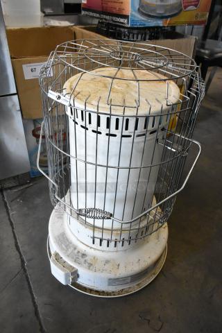 Dura Heat DH-D kerosene-fired heater, floor style. Features a protective metal cage and visible wear. Ideal for large spaces.