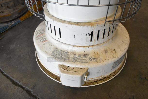 Dura Heat DH-D floor kerosene heater, showing wear and rust, with safety and operating instructions visible on base.