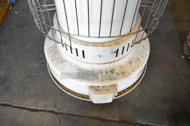2 Dura Heat DH-D kerosene heaters, floor style. Visible wear and dirt. Labels show lighting procedures and safety info.