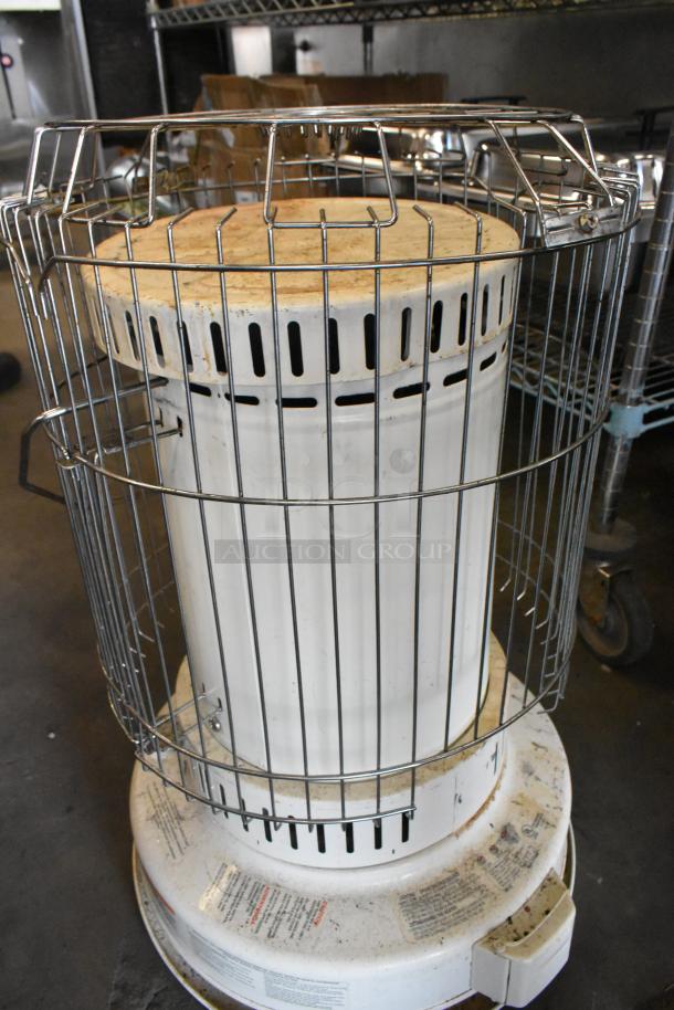 2 Dura Heat DH-D floor style kerosene heaters, white with metal casing, showing usage wear. Labels intact with instructions.