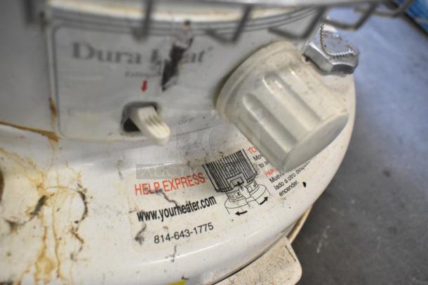 2 Dura Heat DH-D floor kerosene heaters, off-white, visible wear, labeled with URL and contact number, adjustable knob.