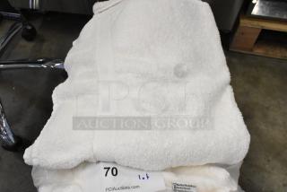 Lot of Golden Touch white towels, pristine condition, soft texture. Includes care label; ideal for luxury use.