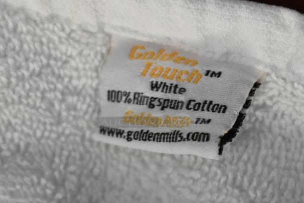 Golden Touch white towel tag, 100% ring-spun cotton, brand Golden Mills, website www.goldenmills.com visible.